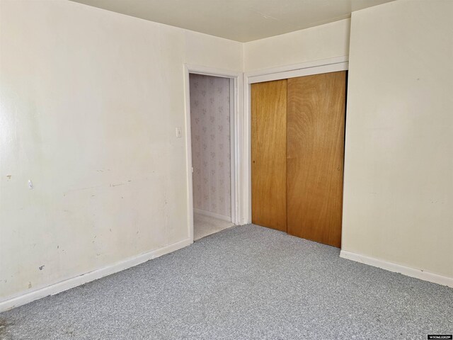 1101 Pine Ave, Kemmerer, WY 83101 - unfurnished bedroom featuring baseboards, a closet, and carpet