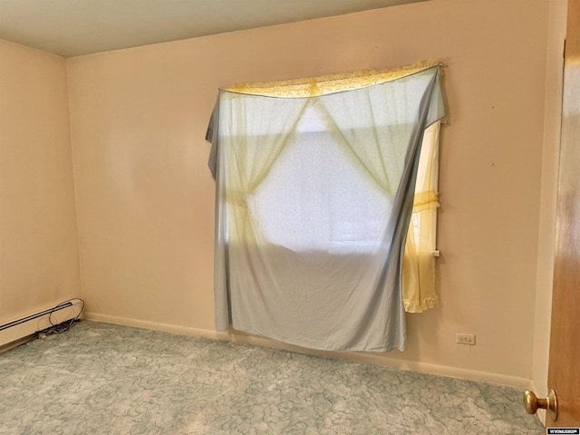 1101 Pine Ave, Kemmerer, WY 83101 - carpeted empty room with baseboards and a baseboard radiator