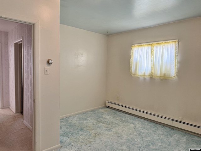 1101 Pine Ave, Kemmerer, WY 83101 - carpeted spare room featuring baseboards and a baseboard radiator