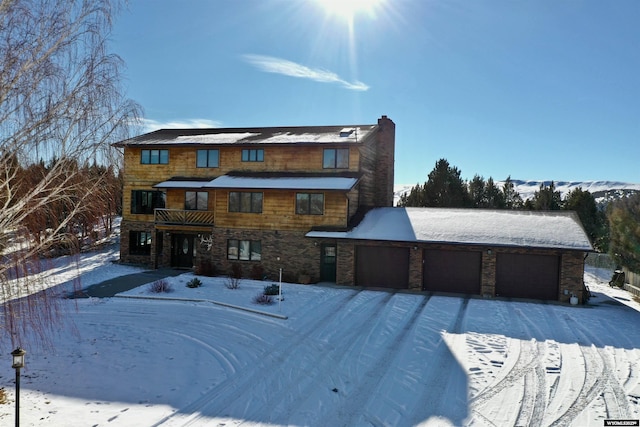 151 Cedar Ridge Dr, Thermopolis, WY 82443 - view of front of house with stone siding, a balcony, and a chimney