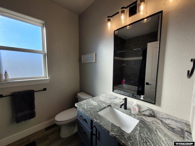 full bathroom featuring wood-type flooring, toilet, vanity, and shower / bath combo