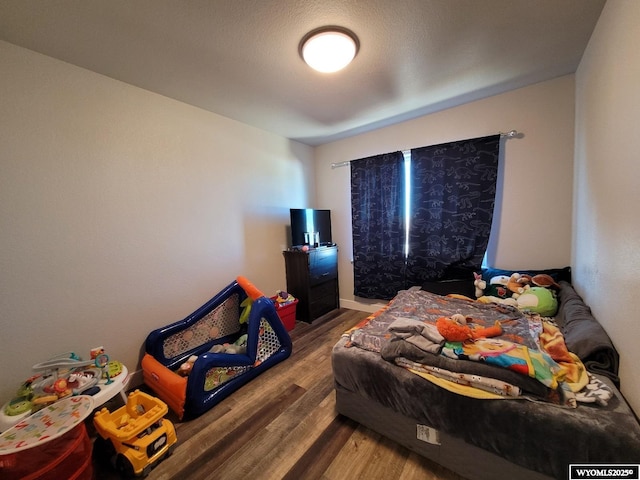 bedroom with hardwood / wood-style flooring