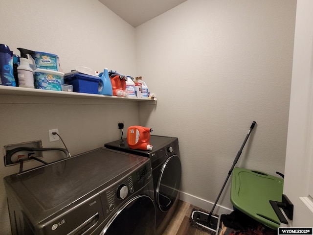 laundry area featuring separate washer and dryer and hardwood / wood-style floors