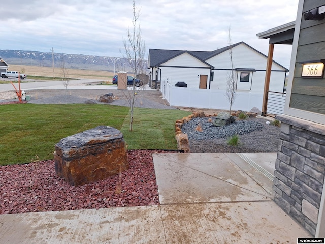 view of yard with a mountain view and a patio area