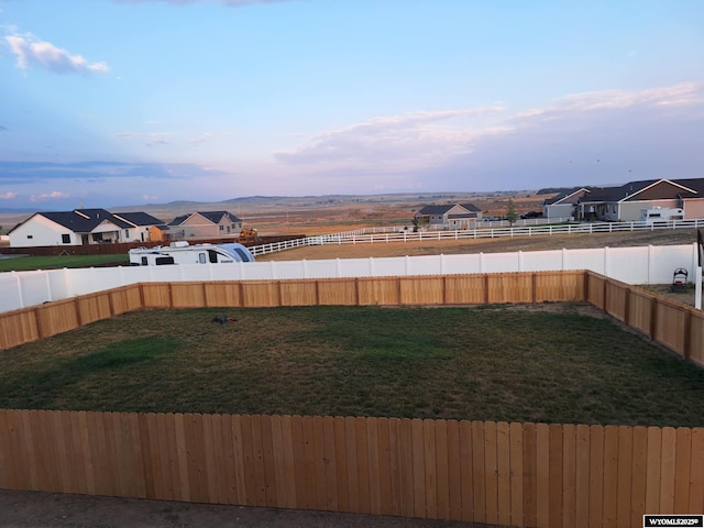 view of yard at dusk