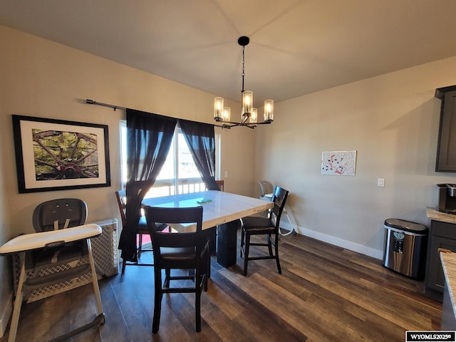 dining room with an inviting chandelier and dark hardwood / wood-style floors