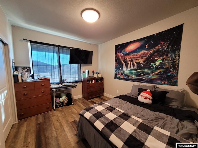 bedroom with hardwood / wood-style flooring