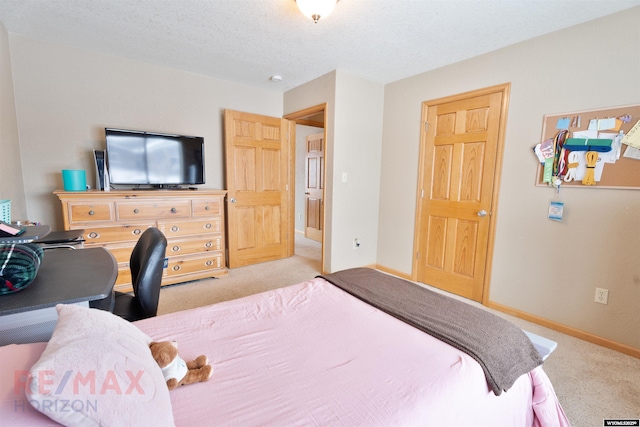 carpeted bedroom with a textured ceiling