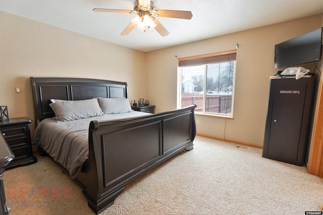 bedroom with ceiling fan and light colored carpet