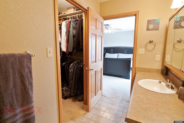 bathroom featuring ceiling fan, tile patterned floors, and vanity