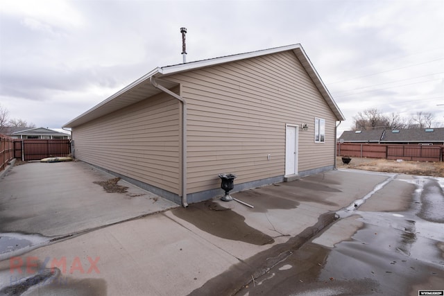 view of property exterior with a patio area