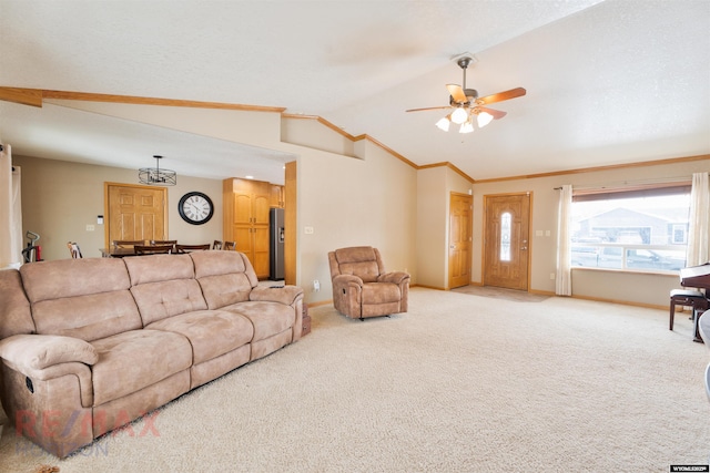 carpeted living room with ceiling fan, ornamental molding, and lofted ceiling