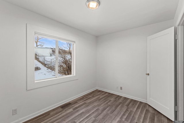 empty room with hardwood / wood-style floors