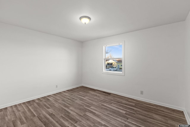 spare room with hardwood / wood-style flooring