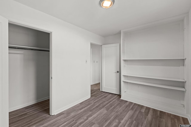 unfurnished bedroom featuring hardwood / wood-style flooring and a closet