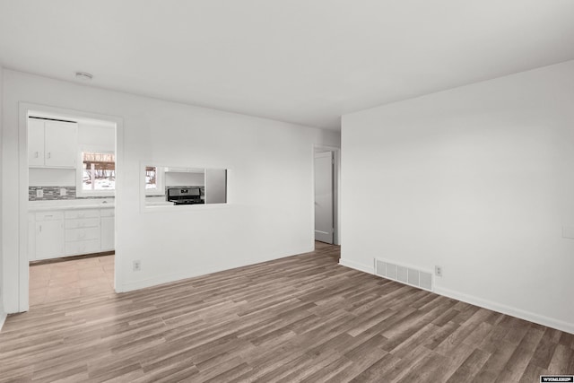 unfurnished living room featuring light wood-type flooring