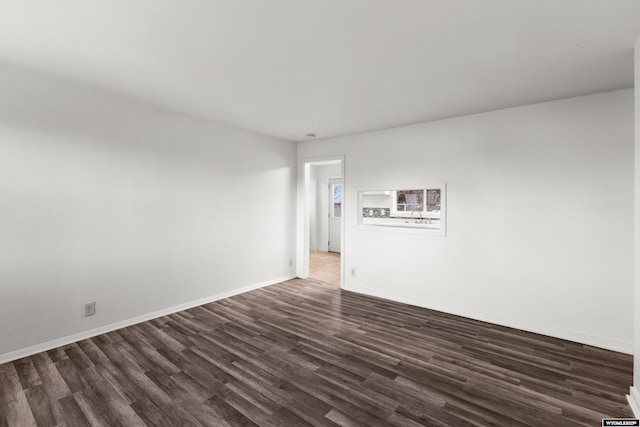 spare room with dark hardwood / wood-style flooring