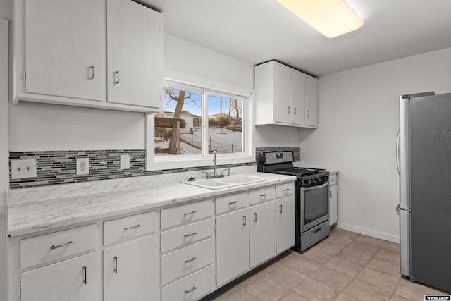 kitchen featuring appliances with stainless steel finishes, sink, and white cabinetry