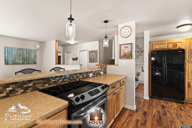 kitchen with black refrigerator with ice dispenser, decorative light fixtures, dark wood-type flooring, stainless steel electric stove, and backsplash