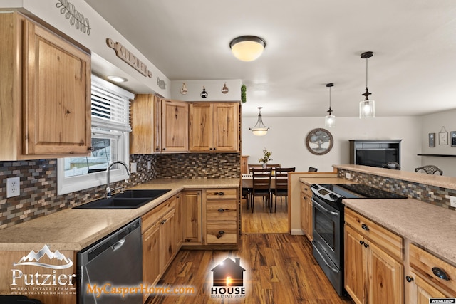 kitchen featuring tasteful backsplash, sink, decorative light fixtures, dark wood-type flooring, and stainless steel appliances