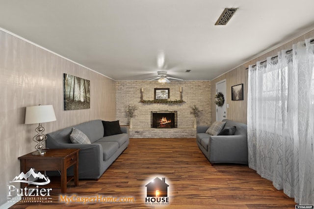 living room with ceiling fan, dark hardwood / wood-style floors, and a fireplace