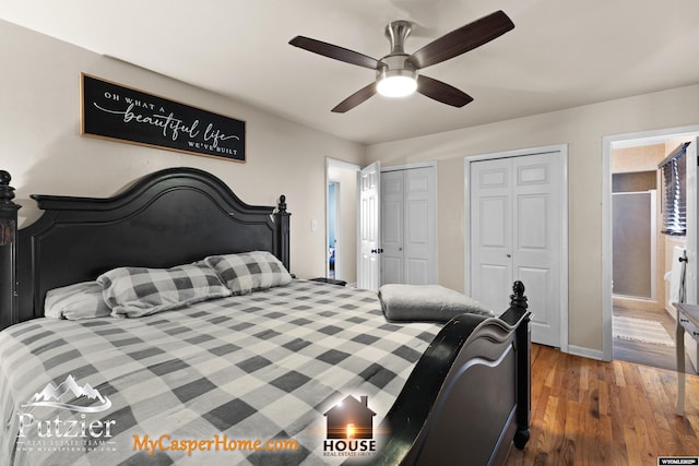 bedroom featuring hardwood / wood-style floors, connected bathroom, two closets, and ceiling fan