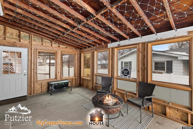 unfurnished sunroom with lofted ceiling