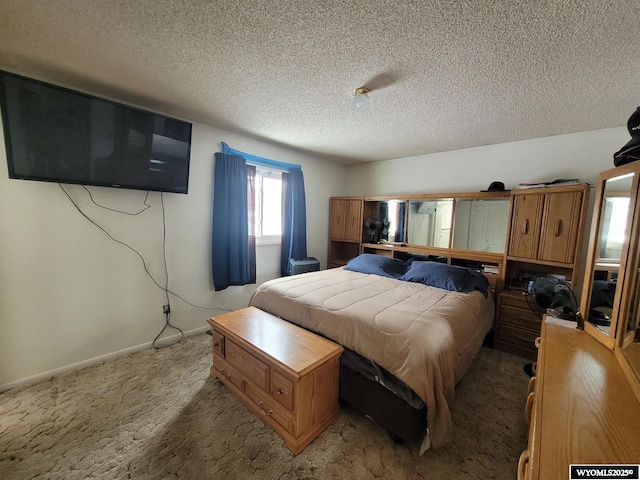 bedroom featuring carpet and a textured ceiling