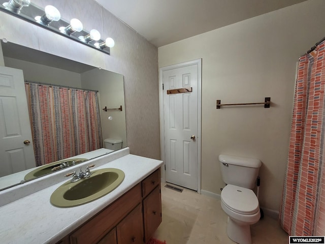 bathroom featuring toilet and vanity