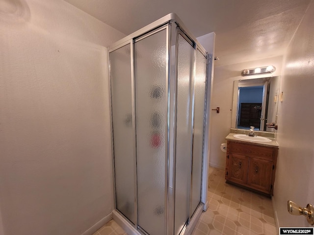 bathroom with an enclosed shower and vanity