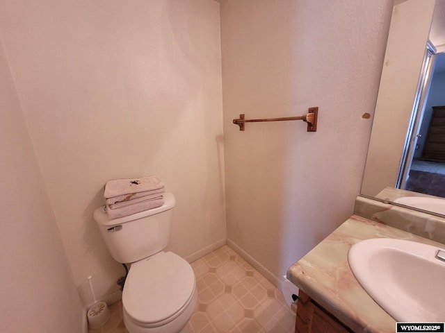 bathroom featuring toilet and vanity