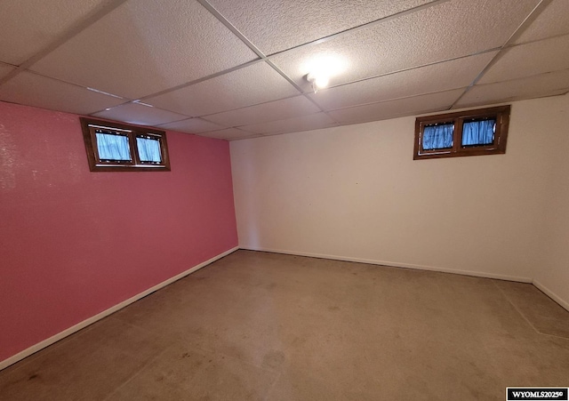 basement with carpet and a drop ceiling