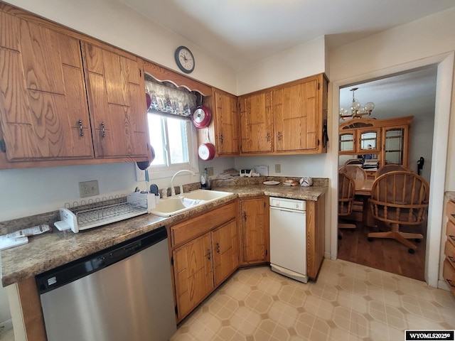 kitchen with an inviting chandelier, stainless steel dishwasher, and sink