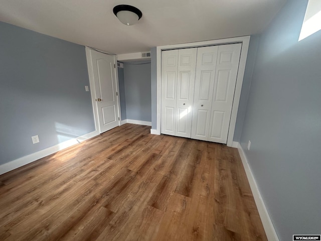 unfurnished bedroom featuring wood-type flooring