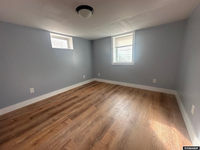 unfurnished room with hardwood / wood-style flooring