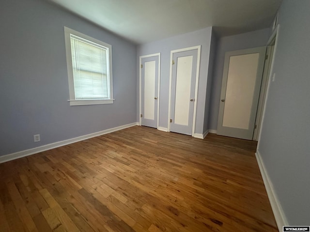 unfurnished bedroom with wood-type flooring