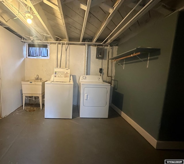 laundry room with washer and dryer, sink, and electric panel