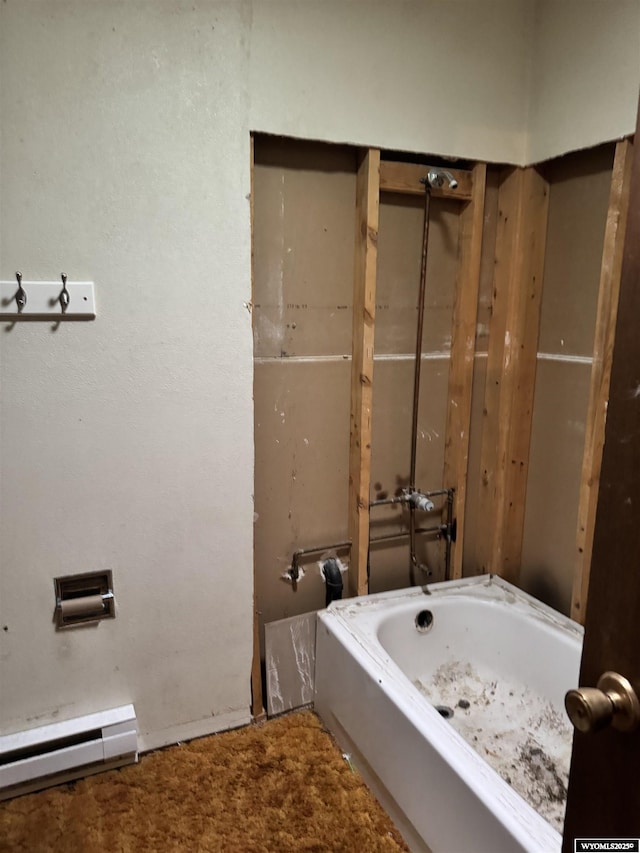 bathroom with a baseboard radiator and a washtub