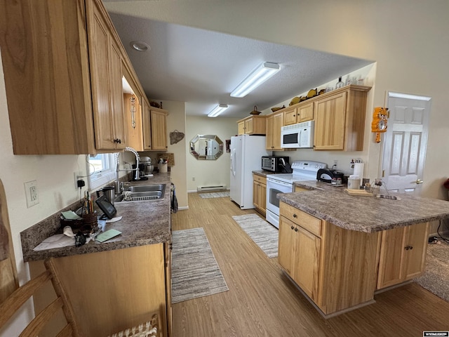 kitchen featuring light wood-type flooring, sink, kitchen peninsula, and white appliances