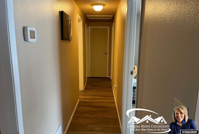 hall featuring dark hardwood / wood-style floors and a textured ceiling