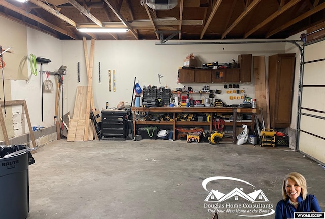 garage with a garage door opener and a workshop area