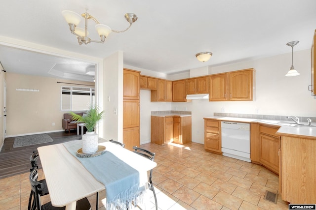 kitchen featuring decorative light fixtures, visible vents, light countertops, open floor plan, and dishwasher