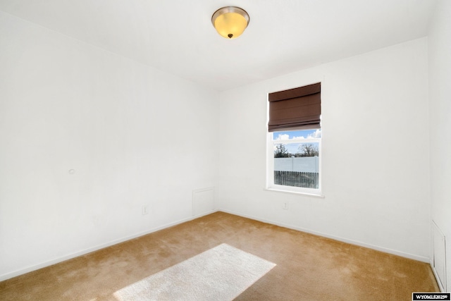 empty room with light carpet and baseboards