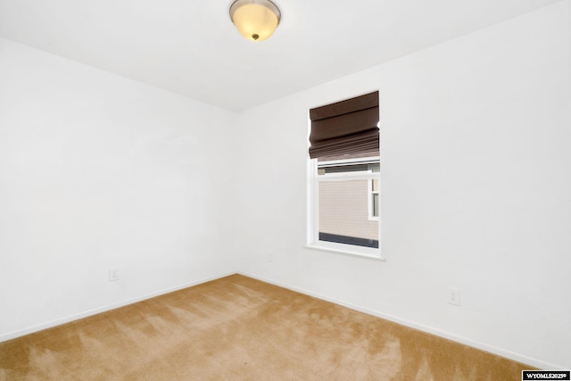 carpeted spare room with baseboards