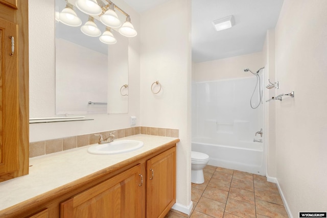 full bathroom featuring toilet, shower / bath combination, vanity, baseboards, and tile patterned floors