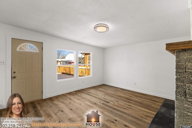 entryway featuring a textured ceiling and hardwood / wood-style flooring