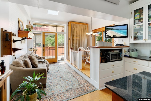 interior space with a chandelier and light hardwood / wood-style flooring