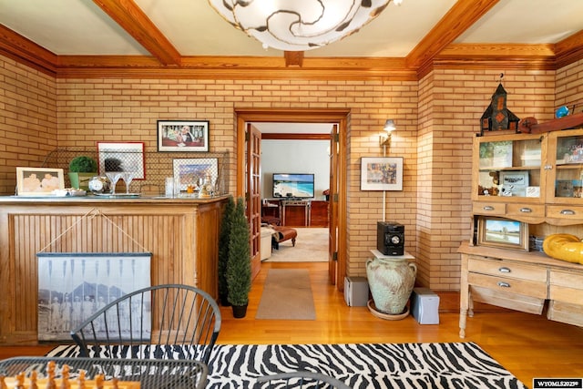 interior space with light wood-type flooring and brick wall