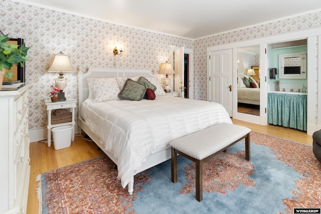 bedroom featuring hardwood / wood-style floors and ornamental molding