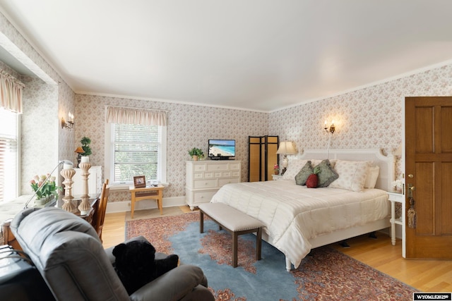 bedroom with hardwood / wood-style flooring and crown molding